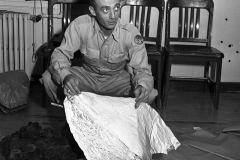 At Fort Worth Army Air Field, Major Jesse A. Marcel (looking left) of Houma, LA - holding foil debris from Roswell, New Mexico, UFO incident, 07/08/1947